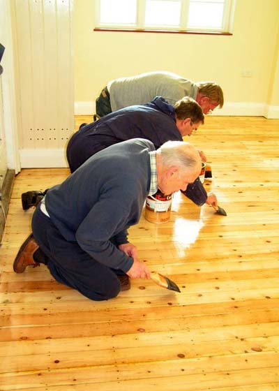 Do-it-Yourselfers cleaning floor 